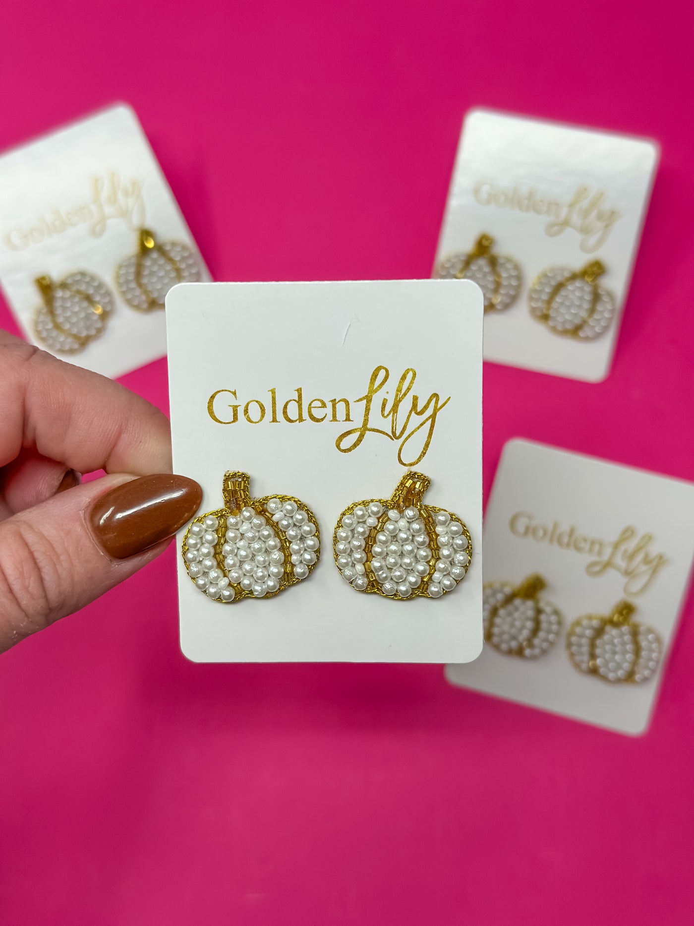 White pearl beaded pumpkin stud earrings with gold trim on Golden Lily card.
