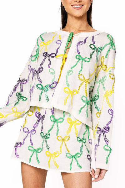 Queen of Sparkles White Mardi Gras Bow Tie Up Sweater with colorful sequin bows—festive, cozy, and perfect for parade season.