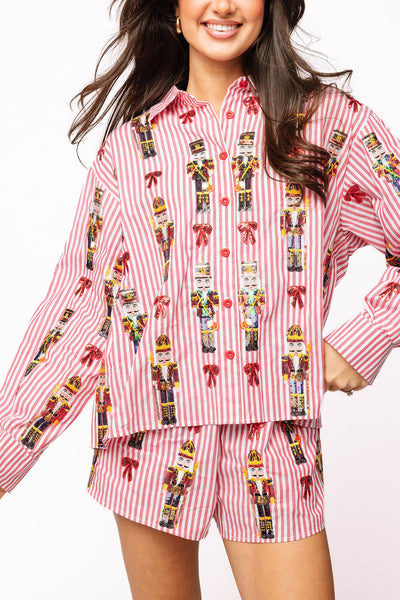 Queen of Sparkles Red Stripe Scattered Nutcracker & Bow Cotton Button Up Top featuring sequin nutcrackers and red bows on striped fabric.