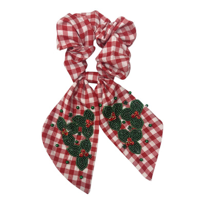 Red gingham scrunchie with bow decorated with beaded green holly leaves and red berries.